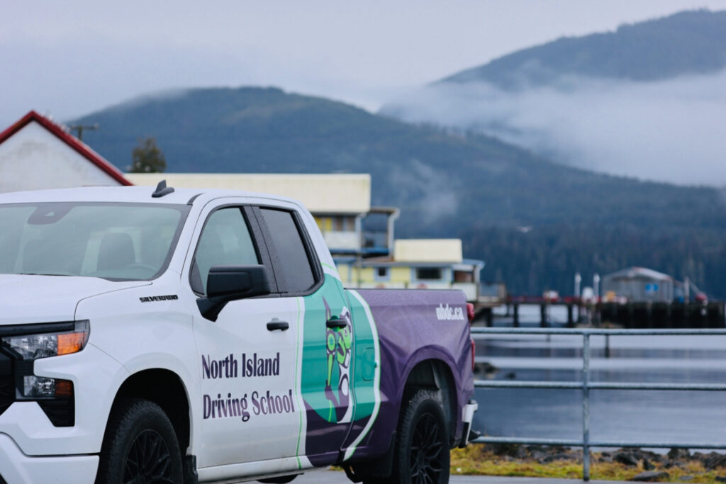 The North Island Driving School pickup truck sits parked in front of the Alert Bay ferry terminal.